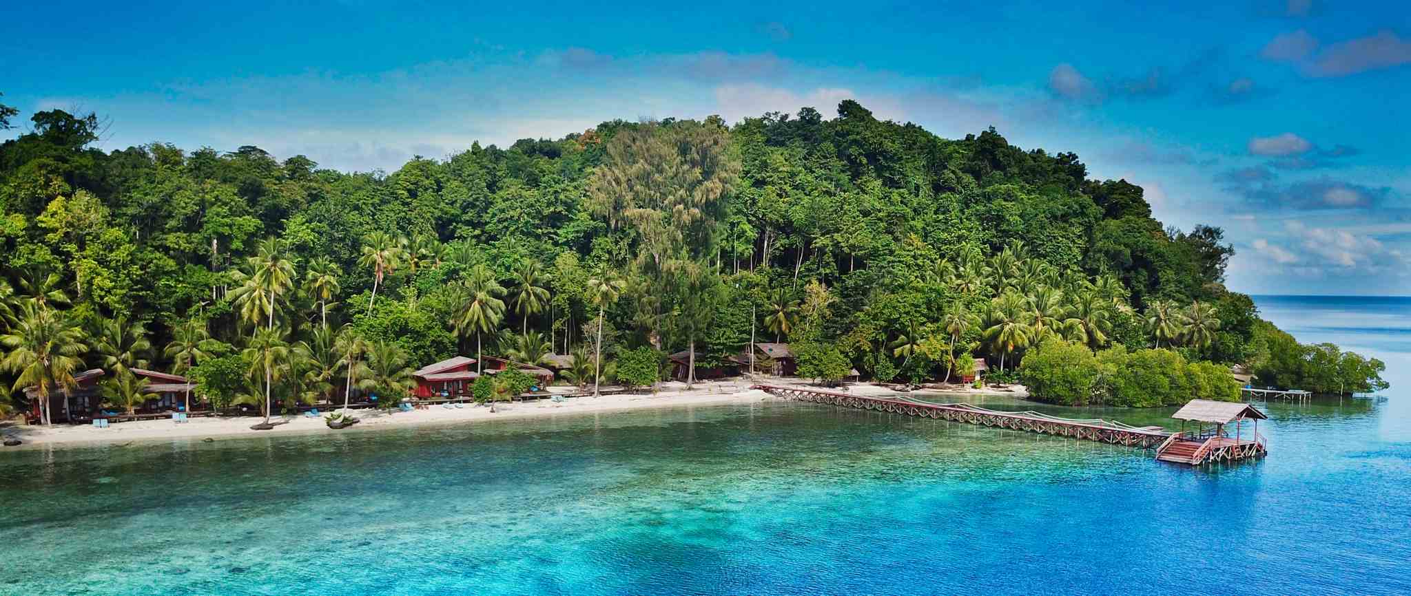 Boat on Yeben beach above corals, Yeben ISland, Raja Ampat